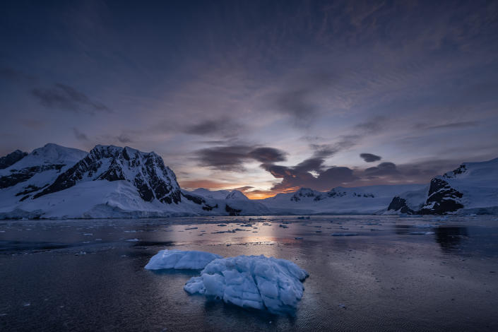 Melting icebergs are seen near a snow-covered island in Antarctica.