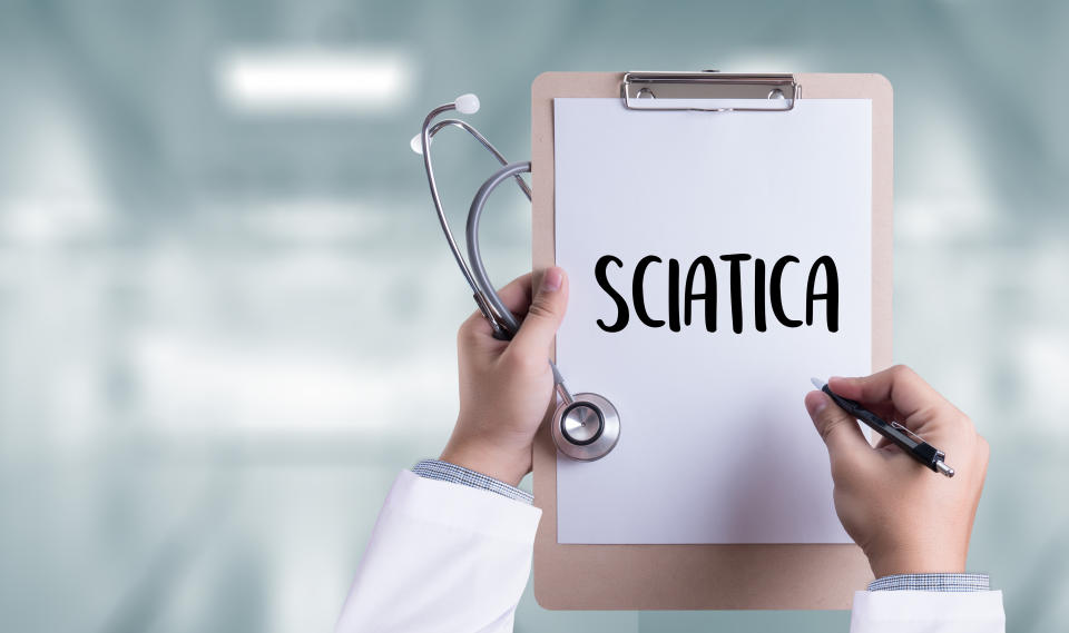 Sciatica doctor hand working Professional Medical Concept. Sciatica is caused by an irritation of the root nerves that lead to the sciatic nerve.(Getty)