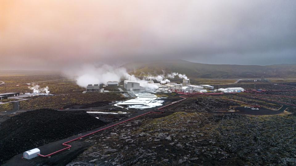 A geothermal power plant in Iceland with steam rising from vents