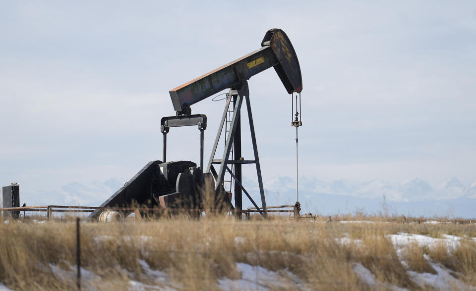 An oil pumper stands in a field along Interstate 25 on Thursday, Nov. 30, 2023, near Erie, Colo. (AP Photo/David Zalubowski)