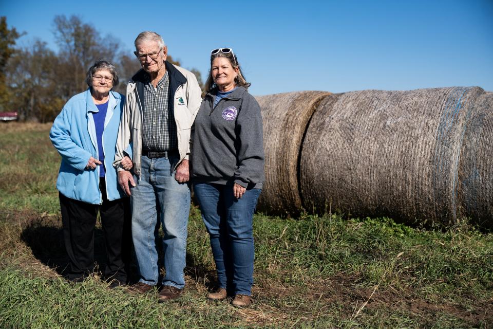 From left, Donna, Bob, and their daughter Jane Knoche pose for a portrait on their land in Gardner, Kansas, Monday, Oct. 30, 2023. The two hope to lease their farmland to a proposed utility-scale solar project, which has been facing growing resistance from county residents.