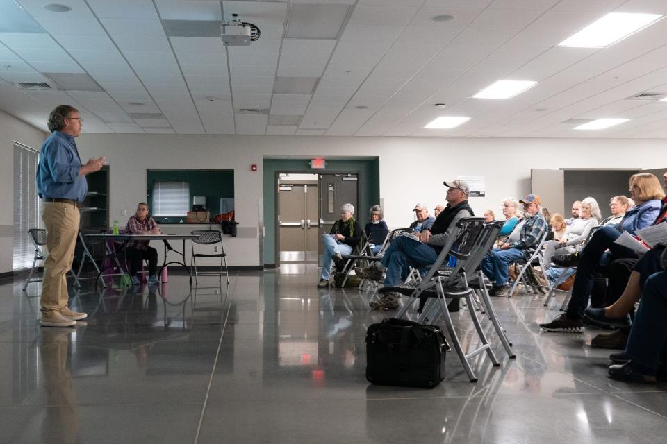 Douglas County farmers concerned about proposed wind turbines on their land listen to Lawrence-Douglas County Planning Commission staff present the second draft of revised wind energy conversion systems regulations Sunday at the Douglas County Fairgrounds.