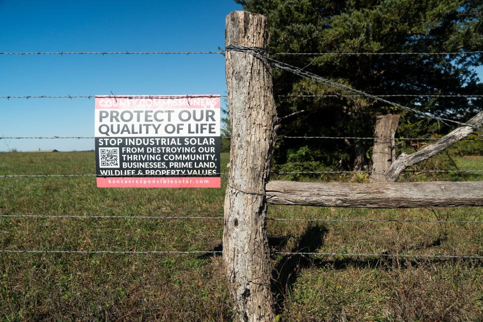 A sign against industrial solar is displayed on a barbed wire fence in Gardner, Kansas, where landowners Bob and Donna Knoche hope to be a part of a large-scale solar utility project on Monday, Oct. 30, 2023.
