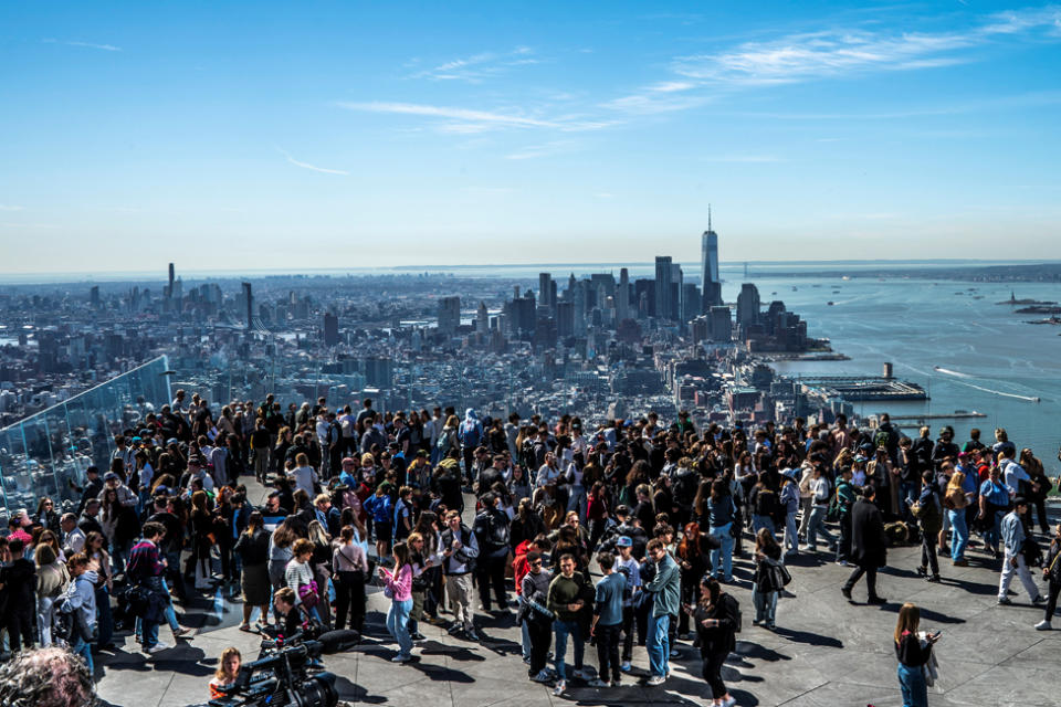 People gather on the observation deck of Edge at Hudson Yards before a partial solar eclipse in New York City, New York, U.S., April 8, 2024.