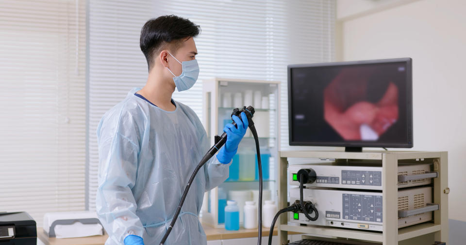 Diagnosing abdominal or GI cancers can include bloodwork, imaging or CT scans and endoscope. (Getty Images) asian male doctor wearing protective gown is doing colonoscopy for elderly man and finding cytopathic effect or tumor