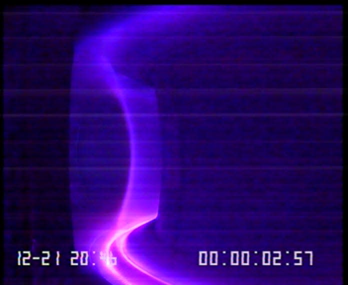 A purplish wavy line against a blue background