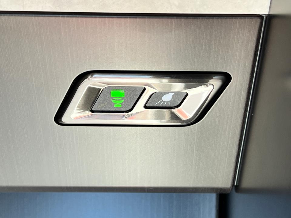The toilet button and a light switch on the Pilatus PC-24