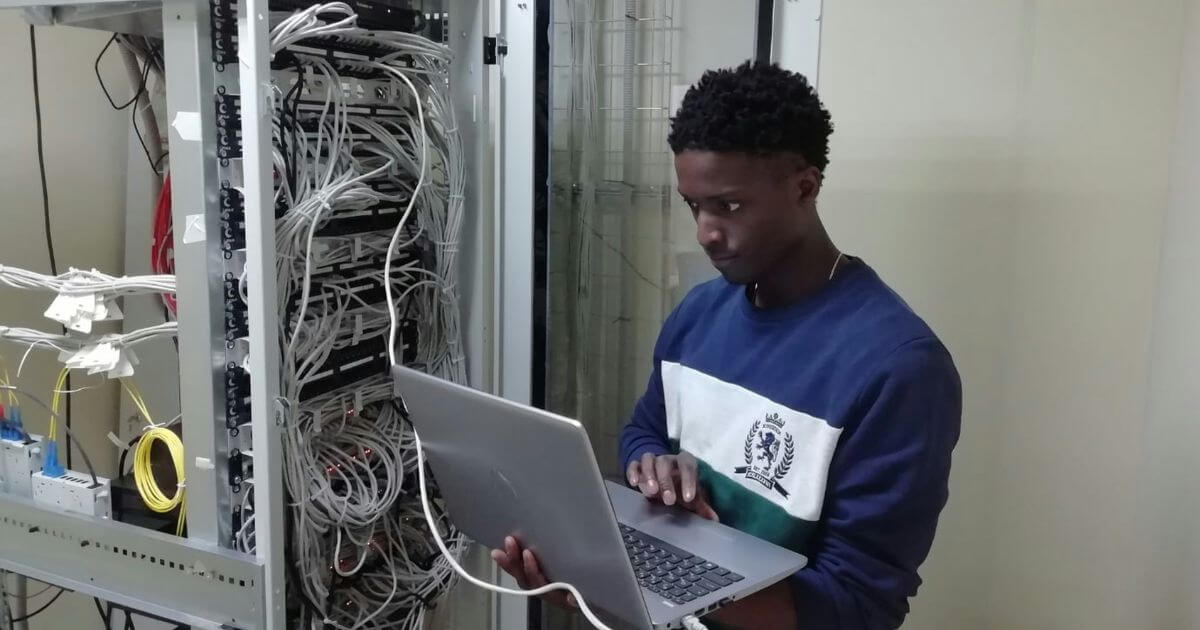 Man standing in data center with cables