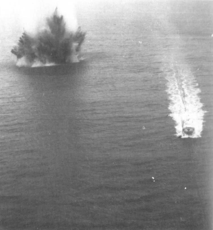 A black and white photo of explosions in water.