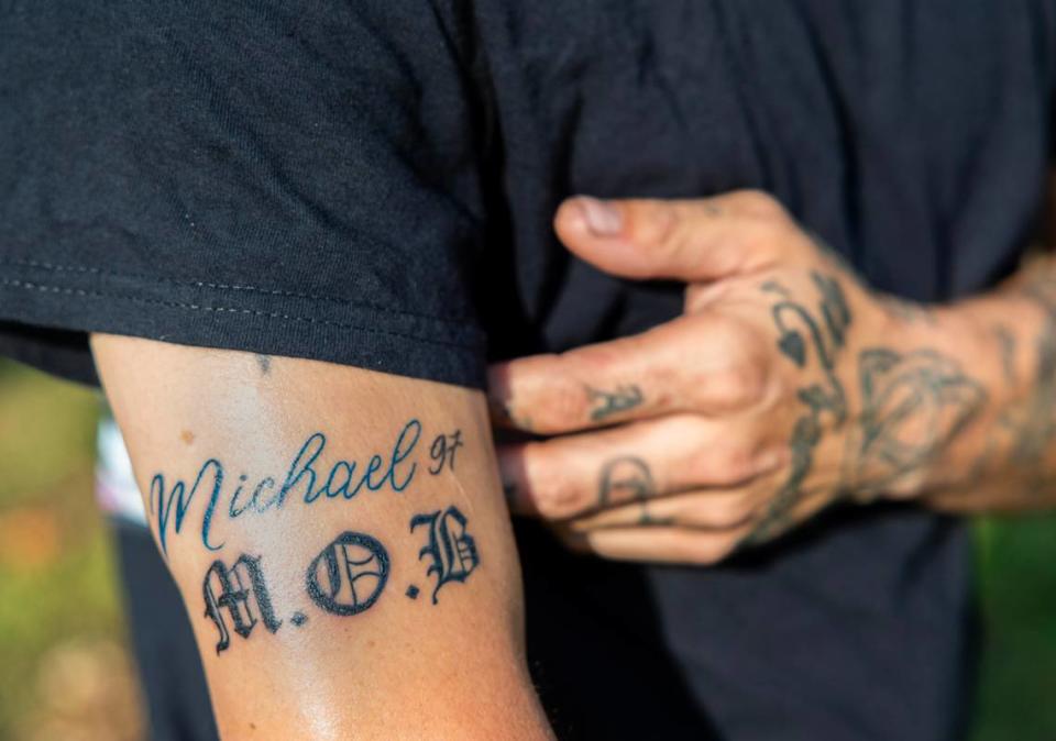 Daniel DeHaan shows a tattoo that memorializes the life of his brother, Michael DeHaan, who was killed in a shooting at a Kansas City gas station Aug. 21.