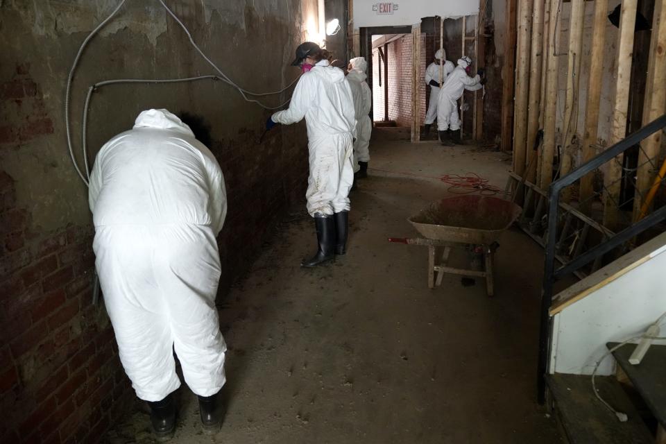 Volunteers chisel plaster off the walls in Marshall, N.C., on Oct. 10, 2024. The city of Marshall experienced flooding caused by the tropical storm winds and rain brought by the remnants of Tropical Storm Helene.