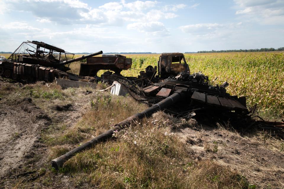 Destroyed Russian military vehicles in a field.