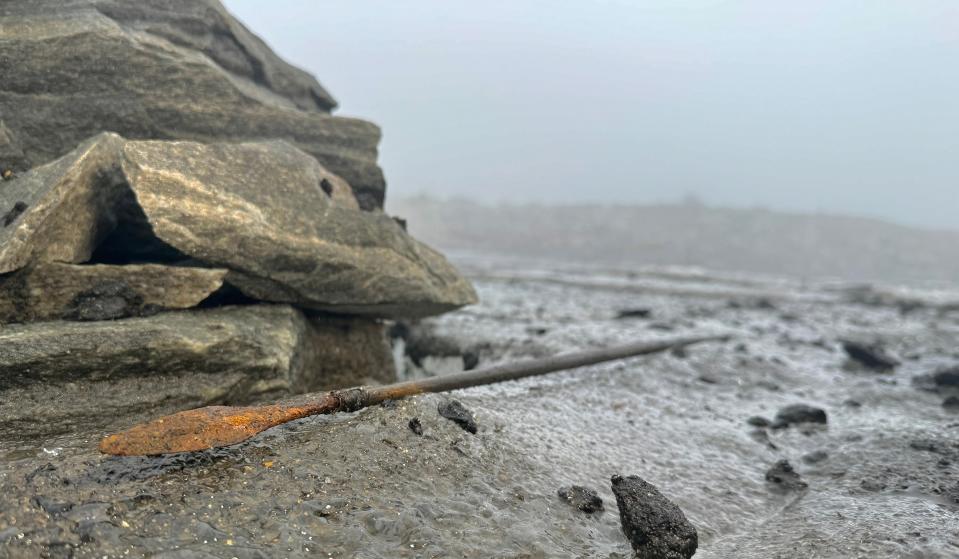 ancient rusty arrow laying on frozen rocky landscape under a foggy sky