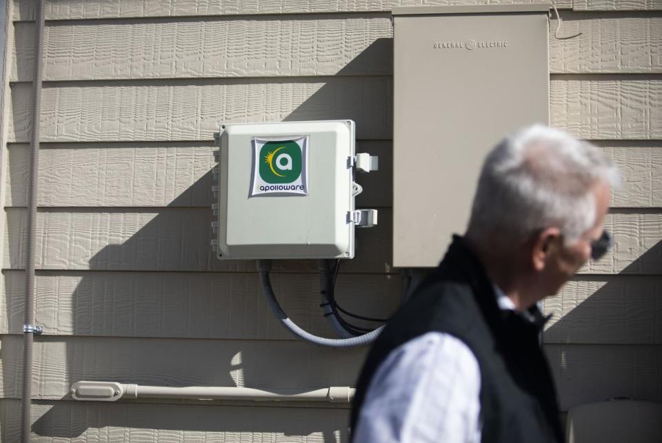 Bill Hetherington, CEO of Bandera Electric Cooperative, stands in front of a power box installed with Apolloware in Boerne, Texas on January 30, 2025.