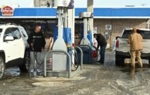 Gas prices fall to four-year lows as millions embark on holiday road trips