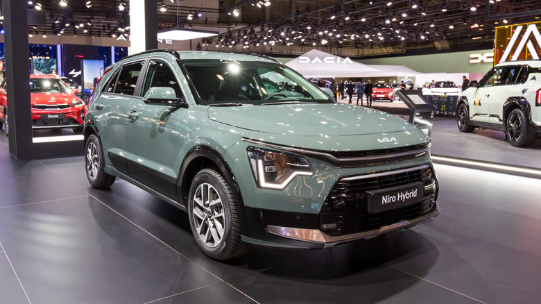 A green 2026 Kia Niro on display at an autoshow.