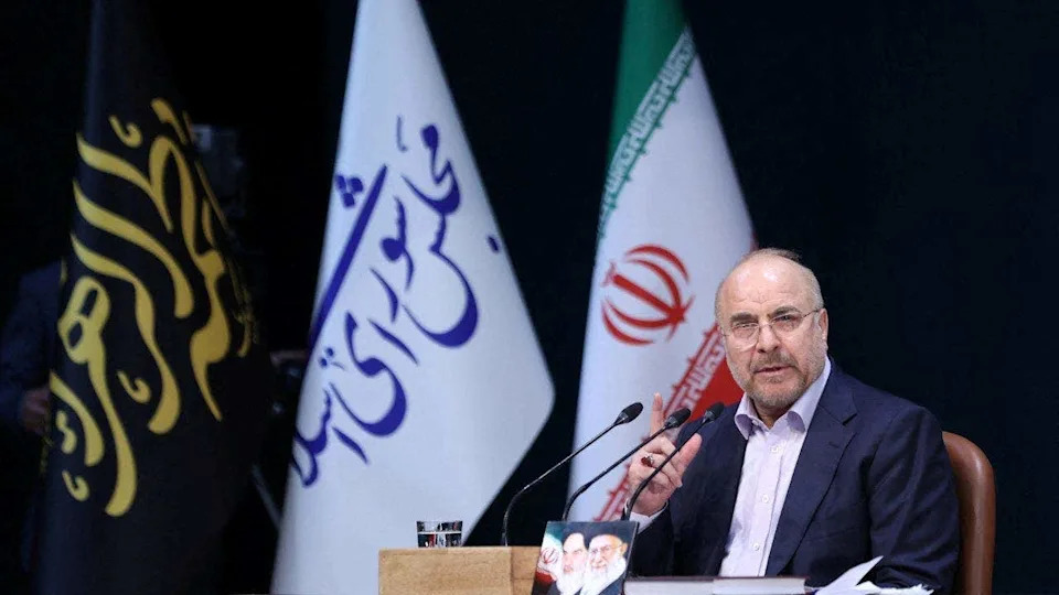 Iranian Parliament Speaker Mohammad Bagher Ghalibaf speaks during a press conference in Tehran, Iran in front of multiple flags