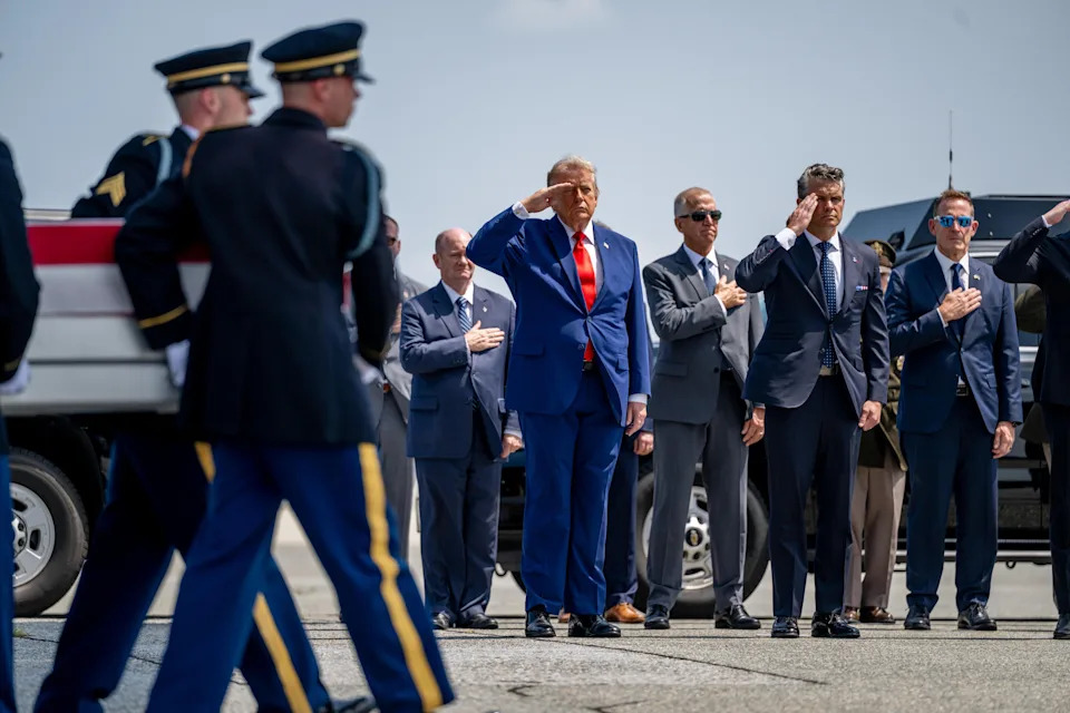 President Trump and Secretary of Defense Pete Hegseth salute as members of a U.S. Army carry team transports a flag-draped transfer case containing the remains of U.S. Army First Lieutenant Tyler James Feehan during a dignified transfer solemn event at Dover Air Force Base in Delaware on Wednesday, July 22, 2026. / Credit: Daniel Heuer / Bloomberg via Getty Images