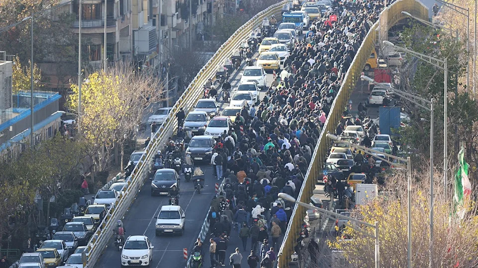Iran hangs 2 protesters in public, crowd cries 'dishonorable' as security fires tear gas